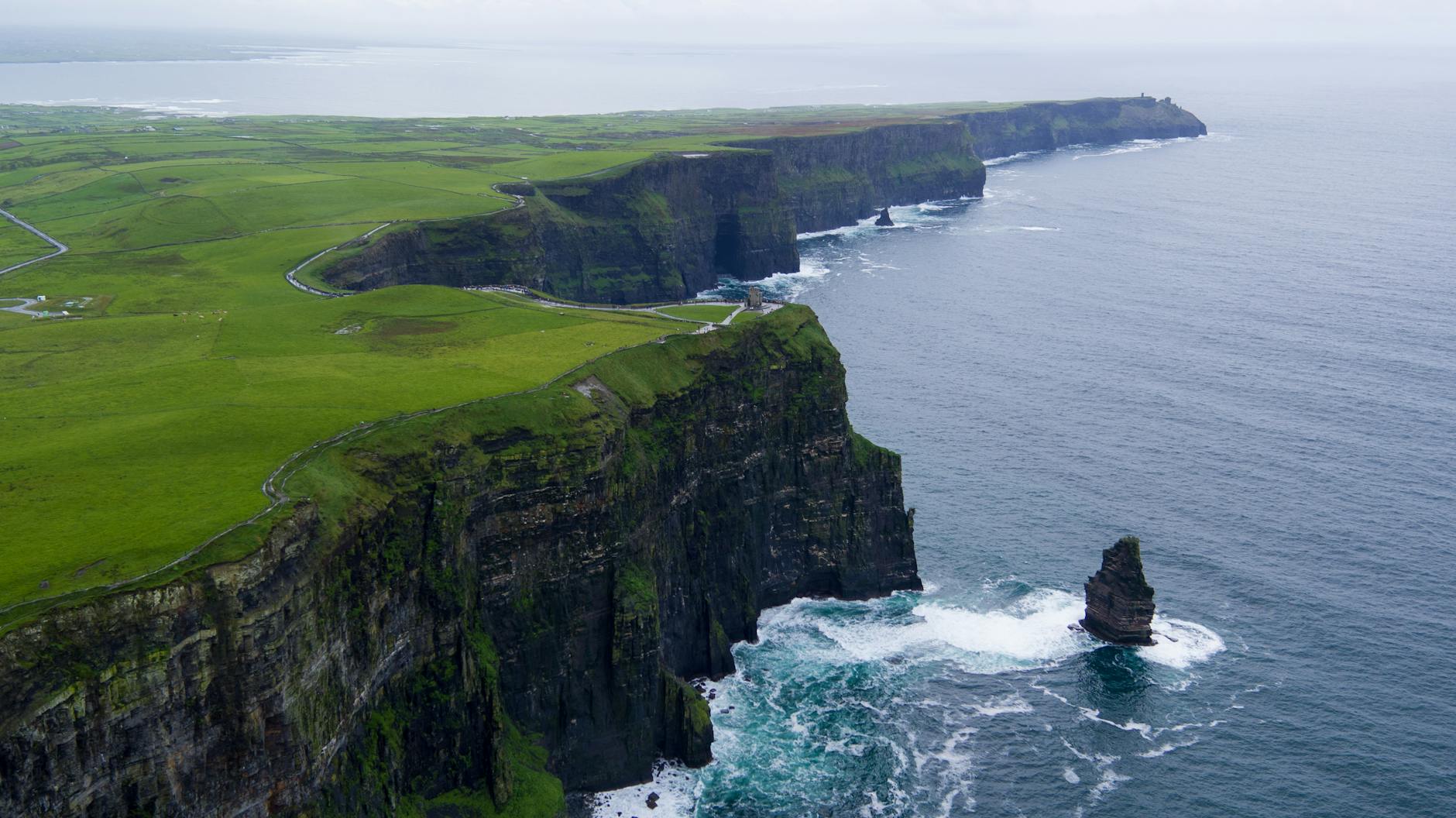 aerial photography of rock next to water body