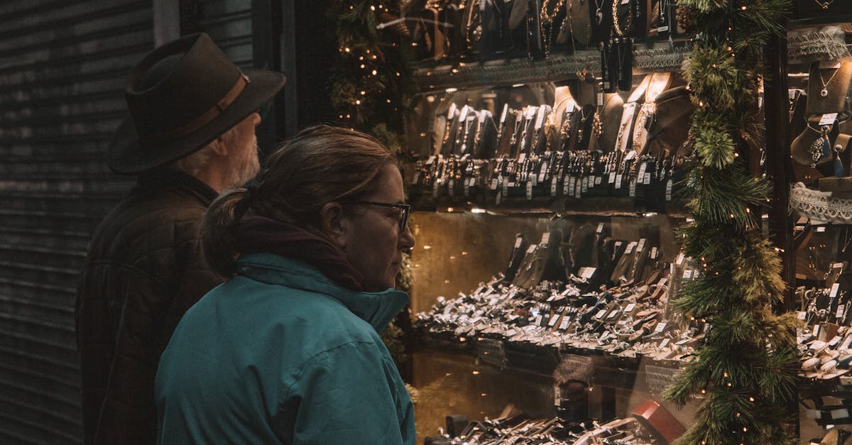 A couple admires jewelry in a beautifully lit shop window on a nighttime stroll in Dublin.