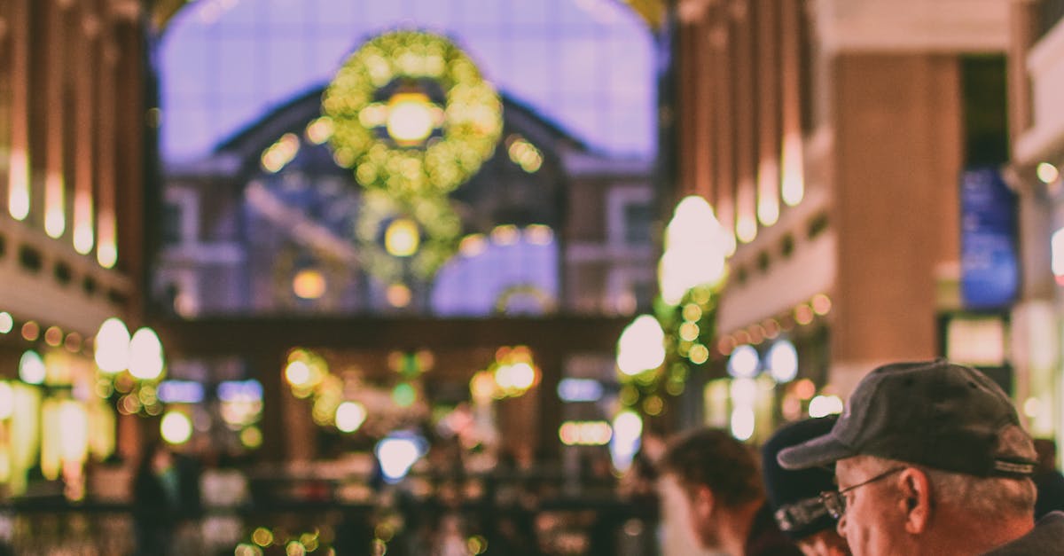 A vibrant indoor shopping mall decorated with Christmas lights and a festive atmosphere.