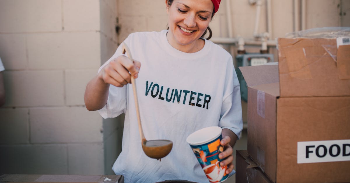 A cheerful volunteer serving food at a donation center, symbolizing generosity and community support.