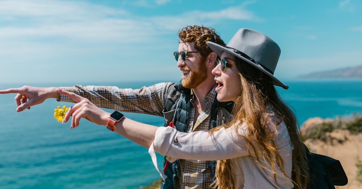 A couple enjoying a scenic coastal view, embracing adventure and nature.