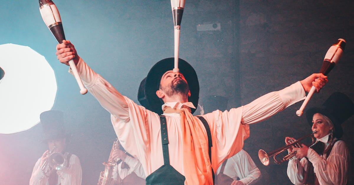 Energetic circus performer juggling clubs in a lively, theatrical setting.