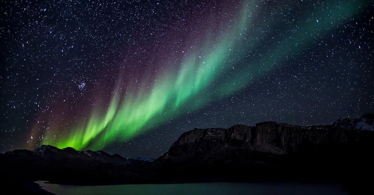 Mesmerizing aurora borealis illuminating the night sky over a serene landscape, capturing nature's beauty.